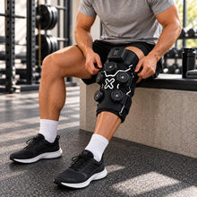 Load image into Gallery viewer, Athlete wearing a cold and heat compression knee massager for post-workout recovery